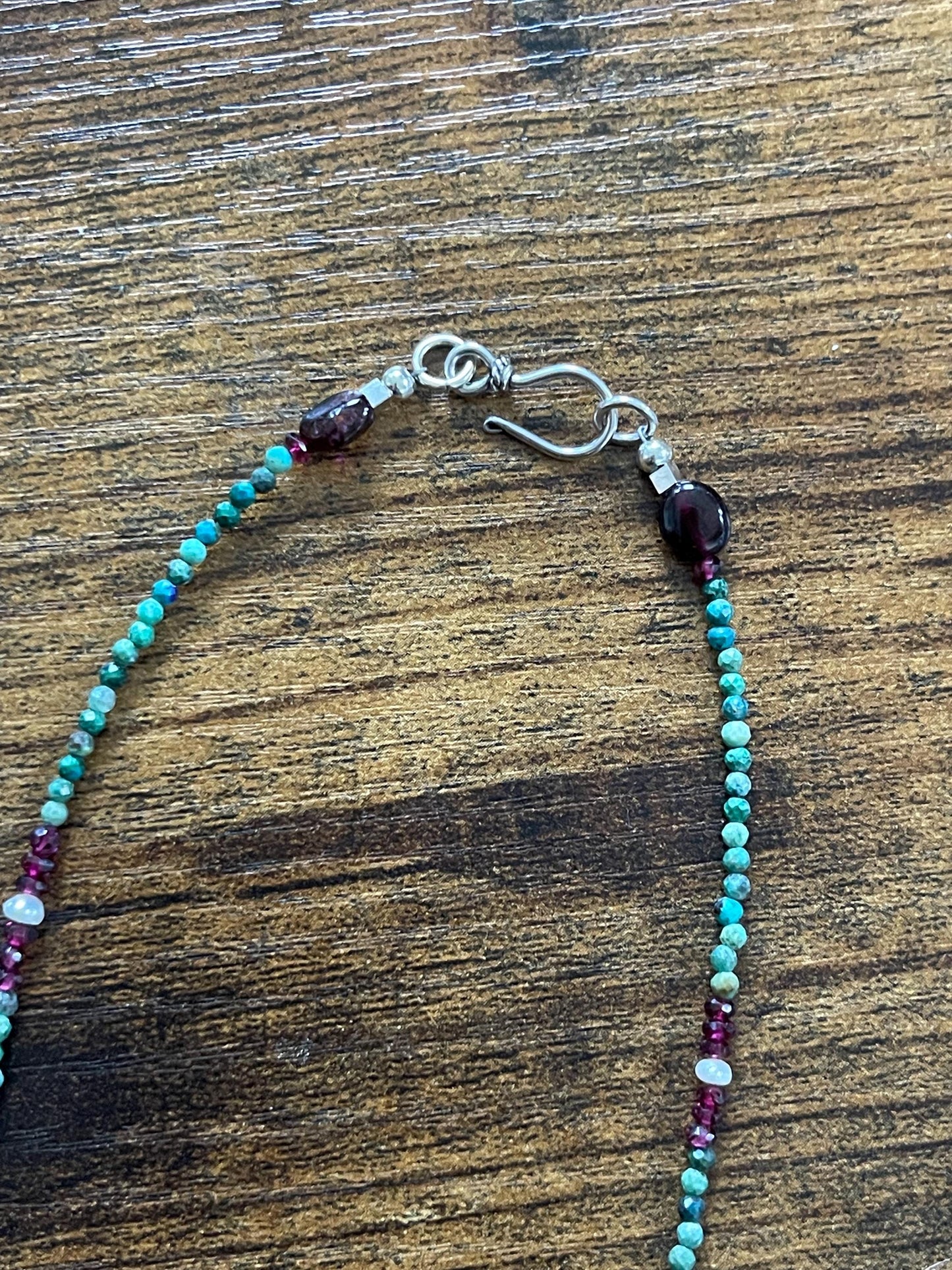 Turquoise, garnet and freshwater pearl necklace with Sterling Silver accents. 18”