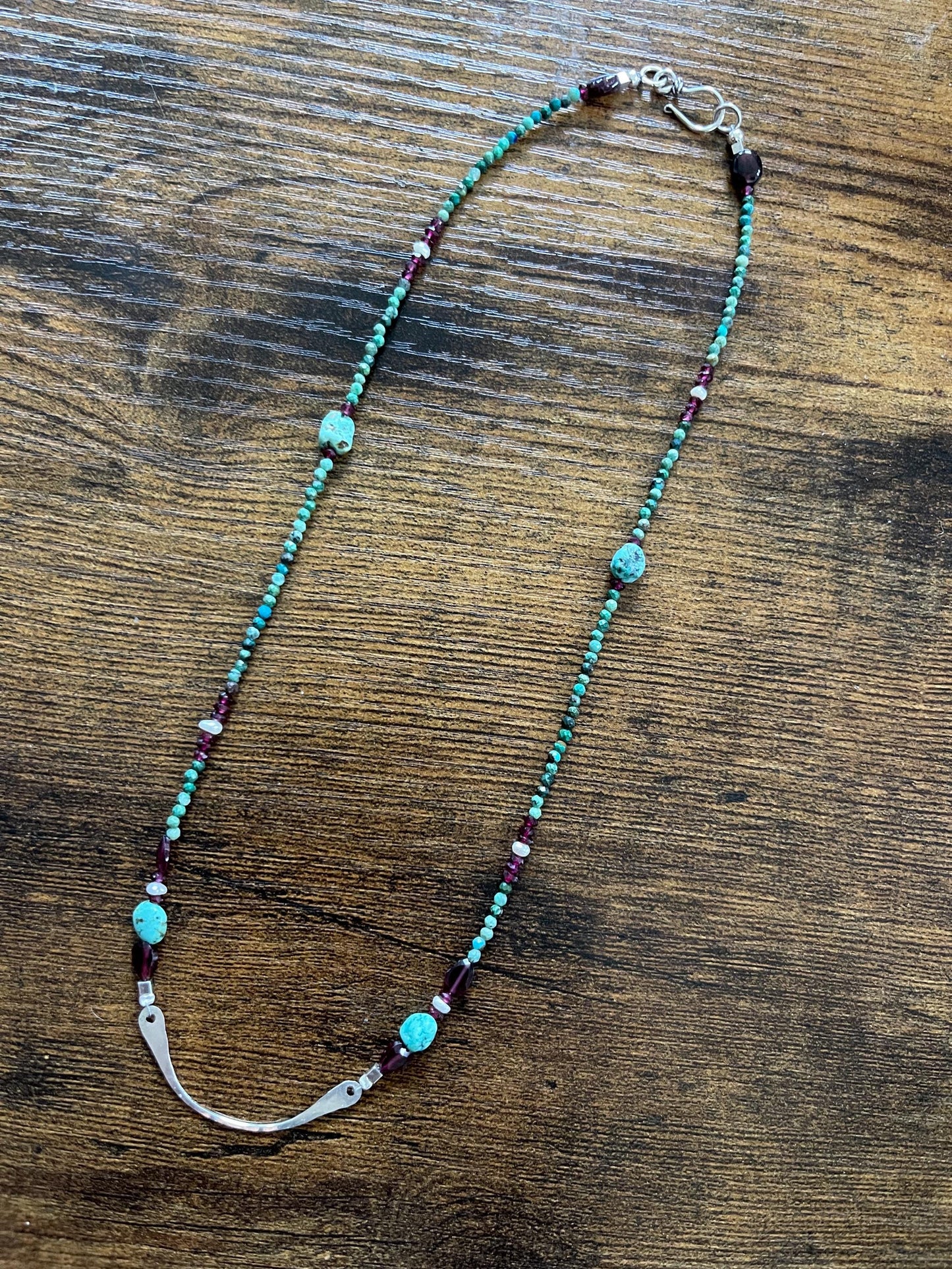 Turquoise, garnet and freshwater pearl necklace with Sterling Silver accents. 18”