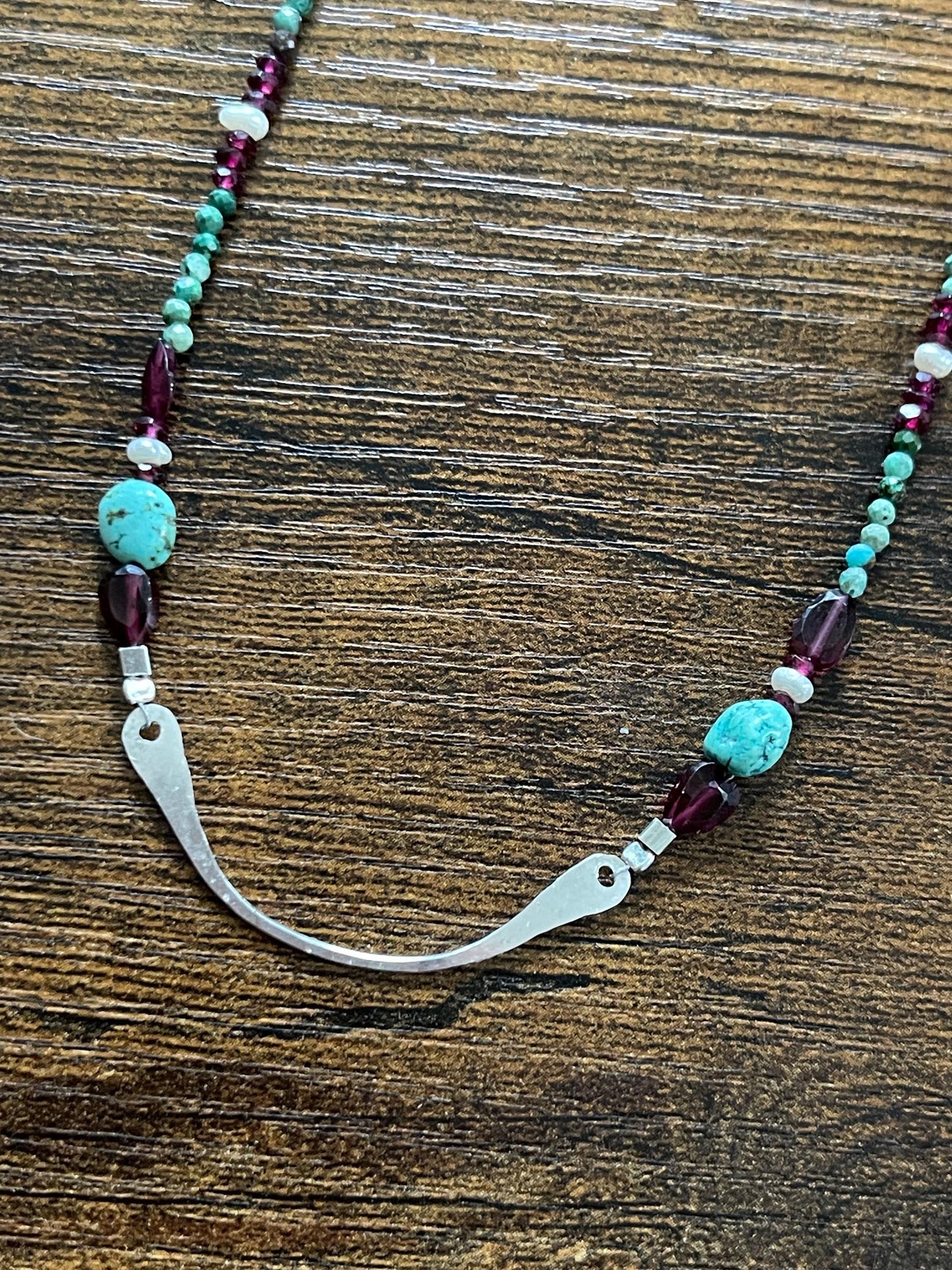 Turquoise, garnet and freshwater pearl necklace with Sterling Silver accents. 18”