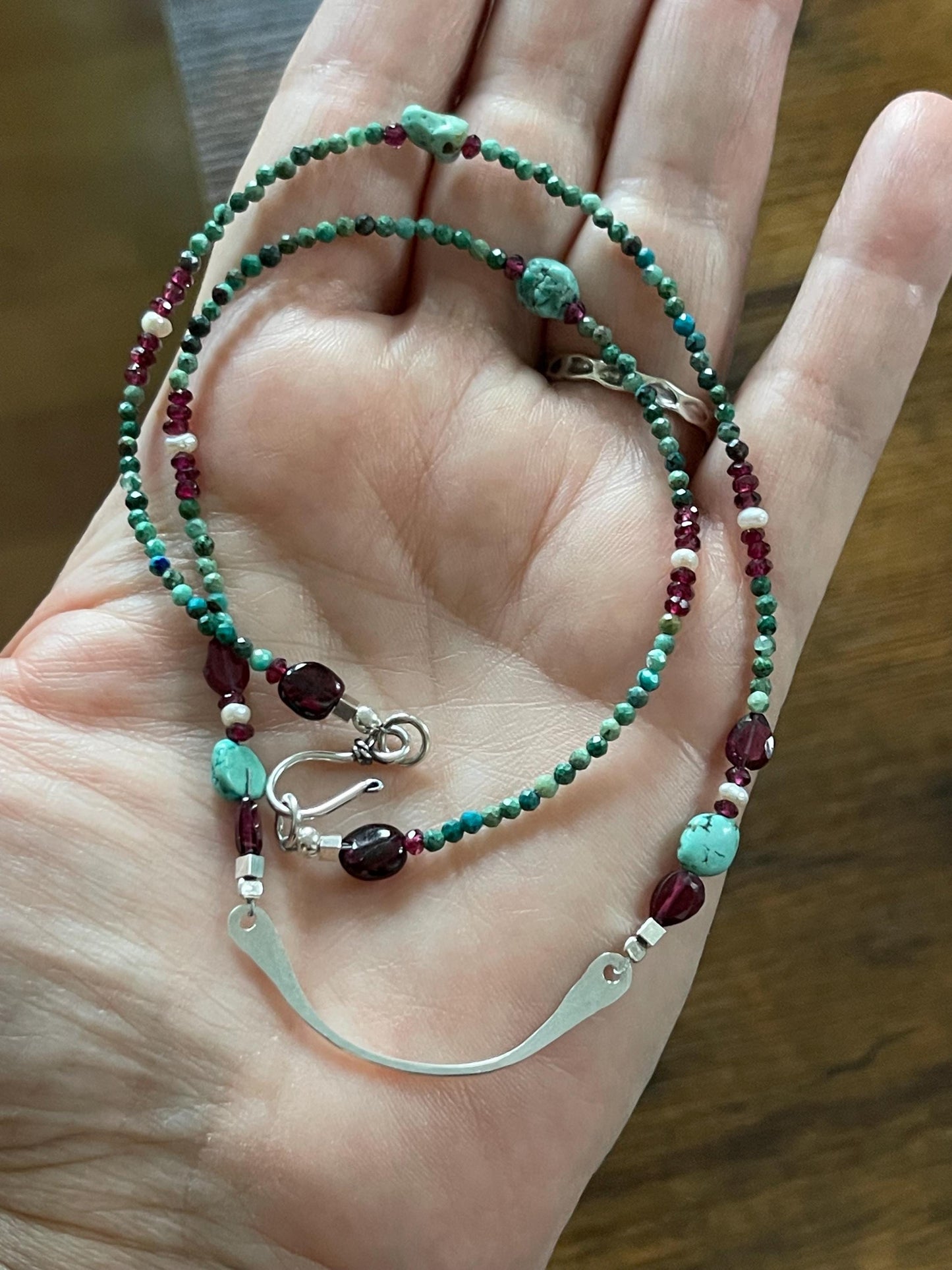 Turquoise, garnet and freshwater pearl necklace with Sterling Silver accents. 18”